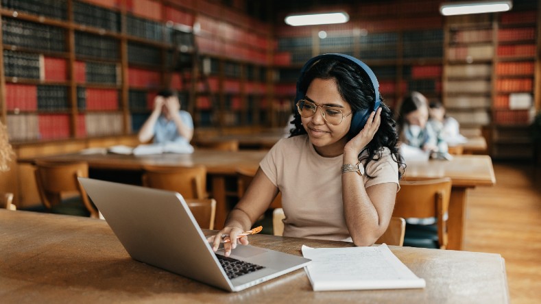 A college student works on her laptop